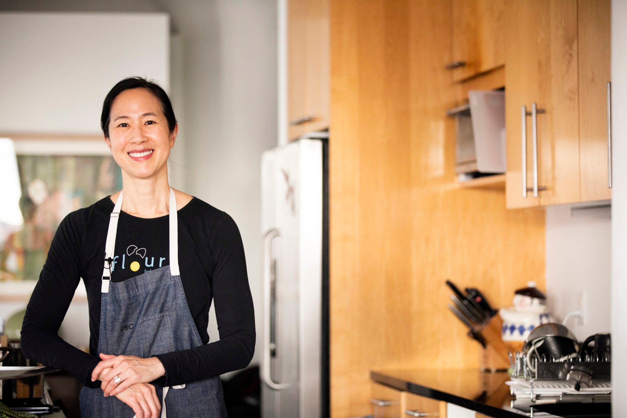 Joanne Chang wears an apron in a kitchen