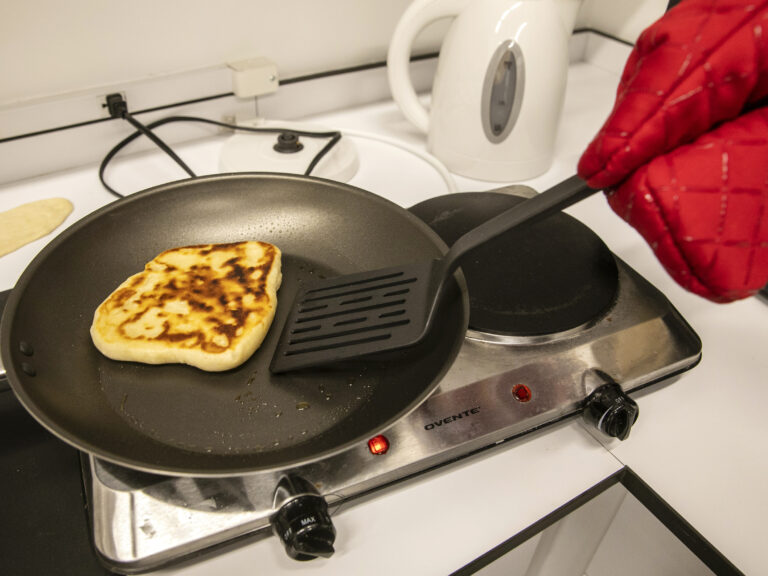 A pancake is flipped in a pan