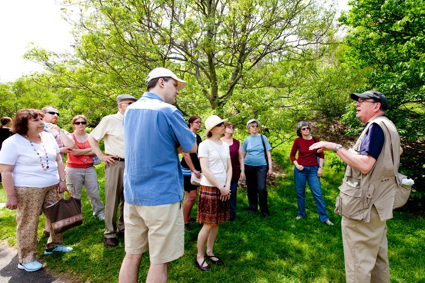 a guide giving a tour in the arboretum