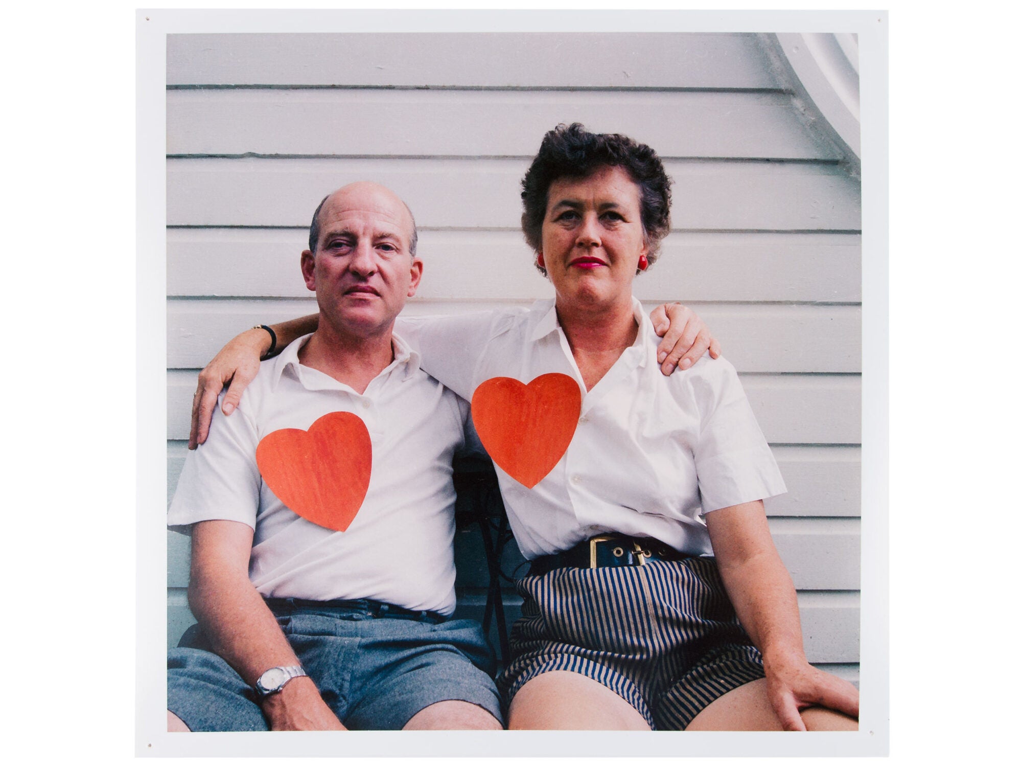 Paul and Julia Child wearing white shirts with a large paper heart on each