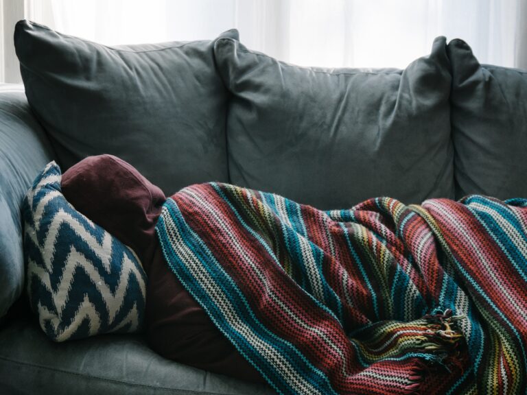 A person napping on a couch