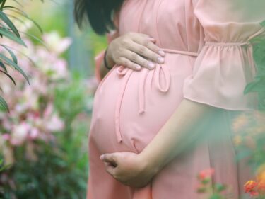 A pregnant woman holds her stomach