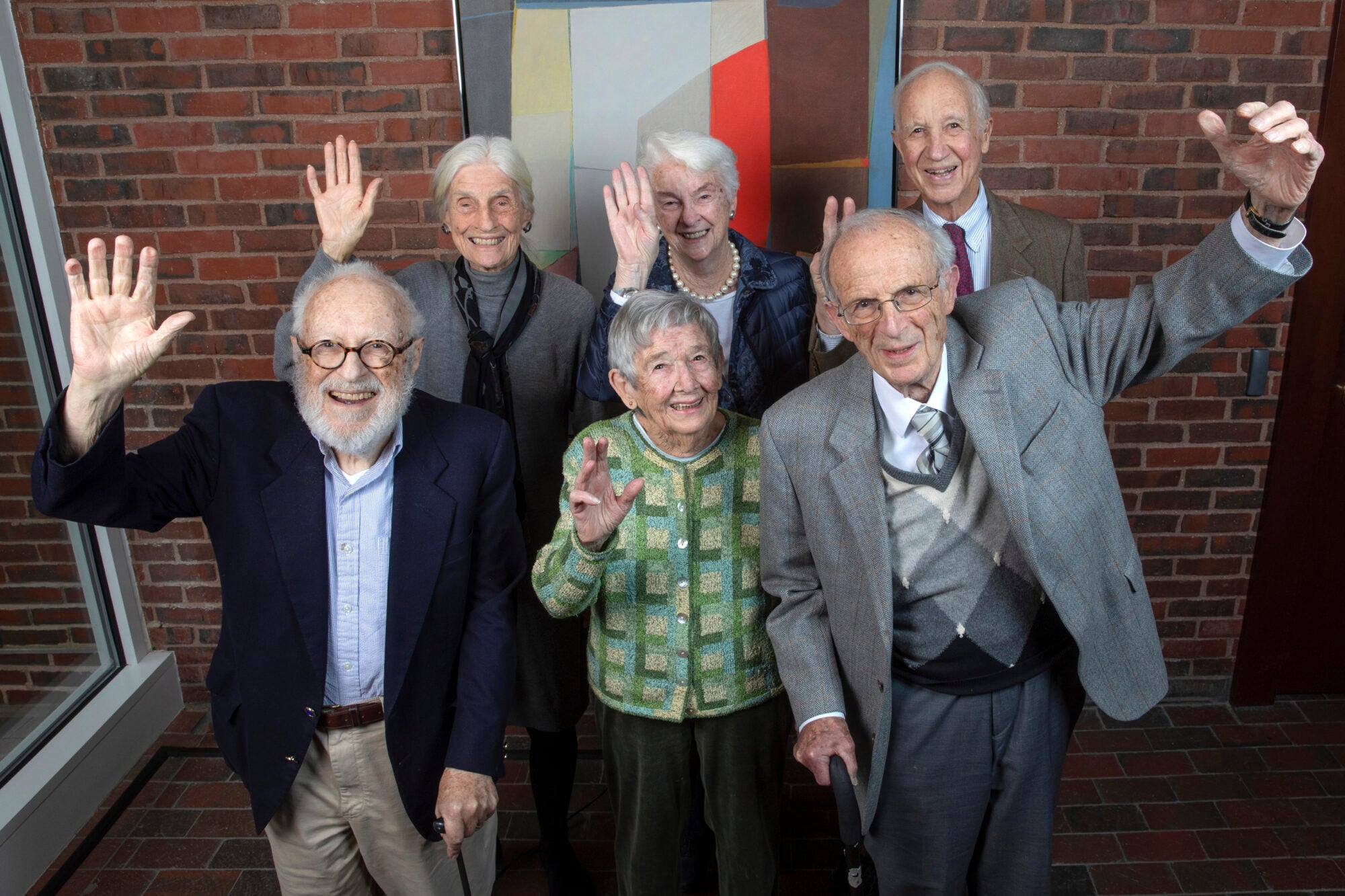 A group of six older folks wave