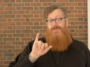 A man doing sign language