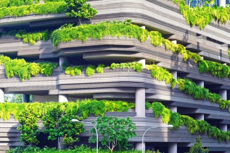 A parking garage with plants growing on it