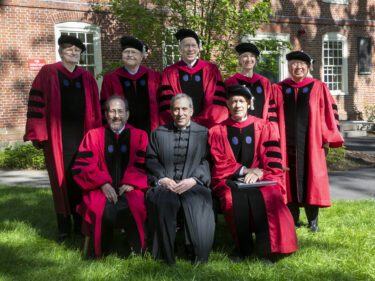 A group of people in red and black robes