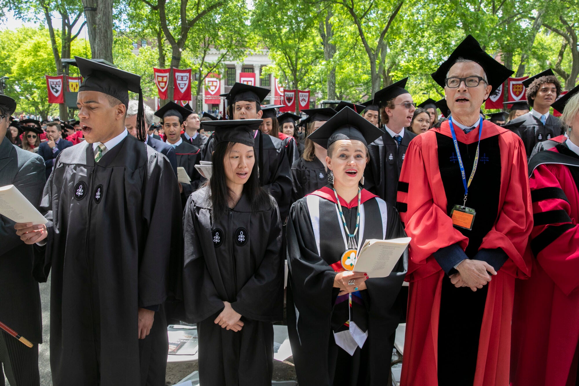 Harvard graduates standing in front of the crowd