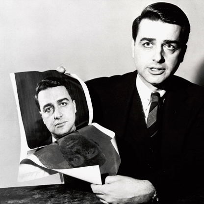 harvard business library A man holding a photograph of himself