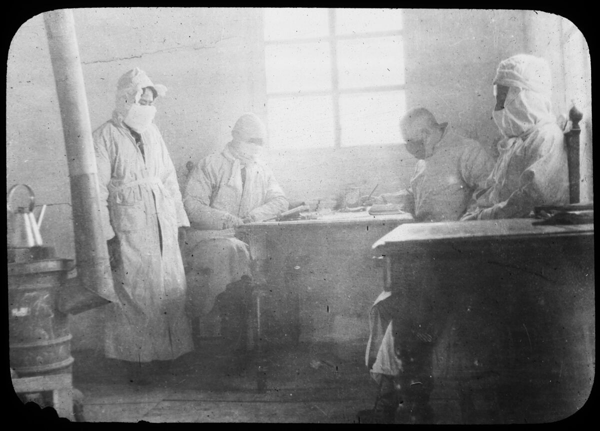 harvard business library A black and white photo of people in 1911 in masks and protective gear