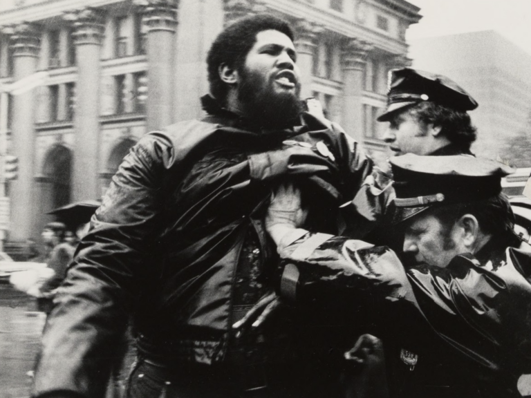 Police pushing an African American man
