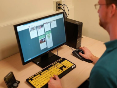A person using assistive technology on a computer