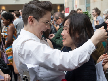 Two people embrace in excitement