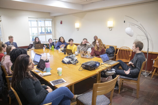 a group of students sitting around a table