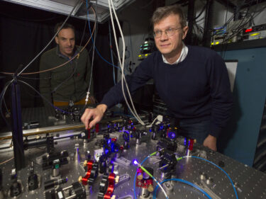 Mikhail Lukin in front of an array of lasers and mirrors