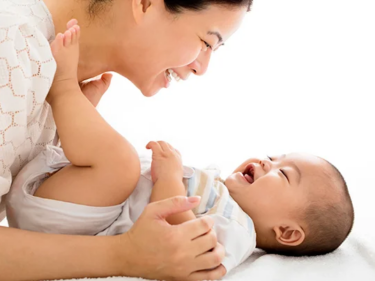 A woman talking to a little baby