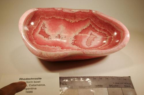 A pink rock carved into a bowl