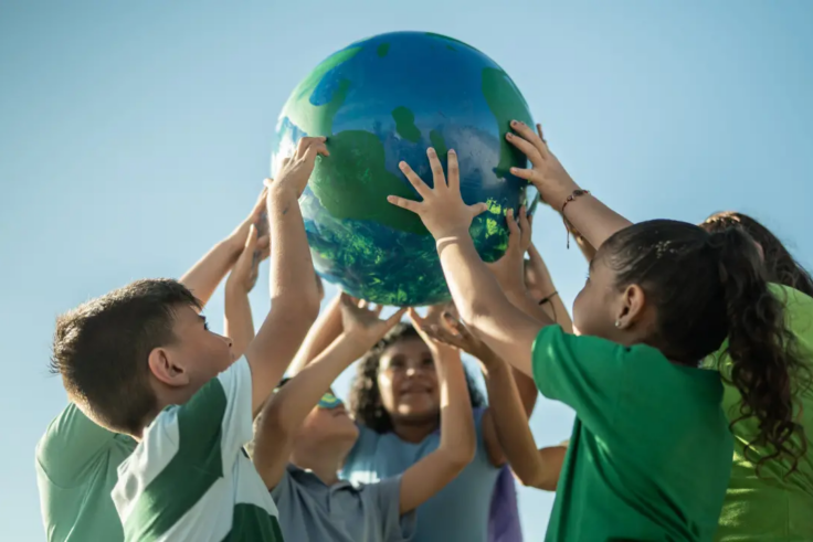 Children holding a globe