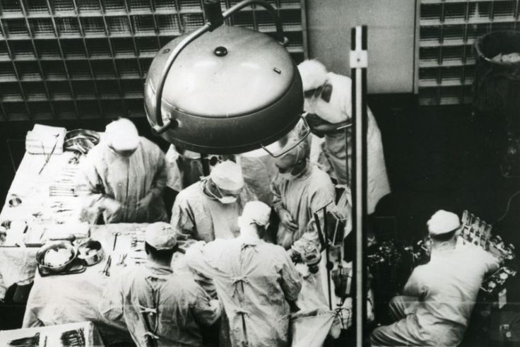 A black and white image of an organ transplant operation