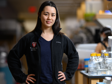 A researcher stands in a lab