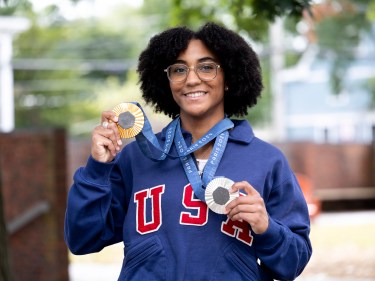 Lauren Scruggs shows off her two Olympic medals in fencing.