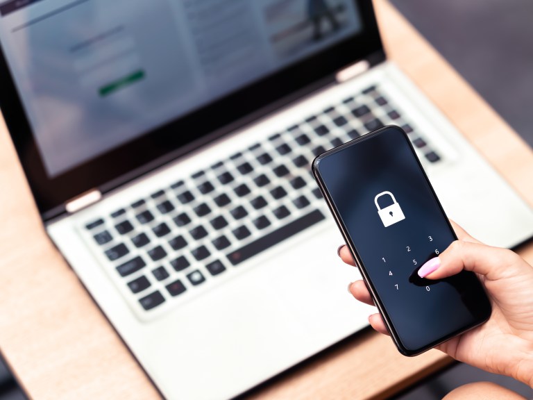 A person logging into their locked phone