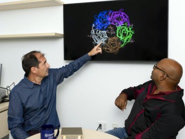 Bernardo Sabatini (left) and Bala Desinghu (right) use a new desktop supercomputer to study disruptions to neurons