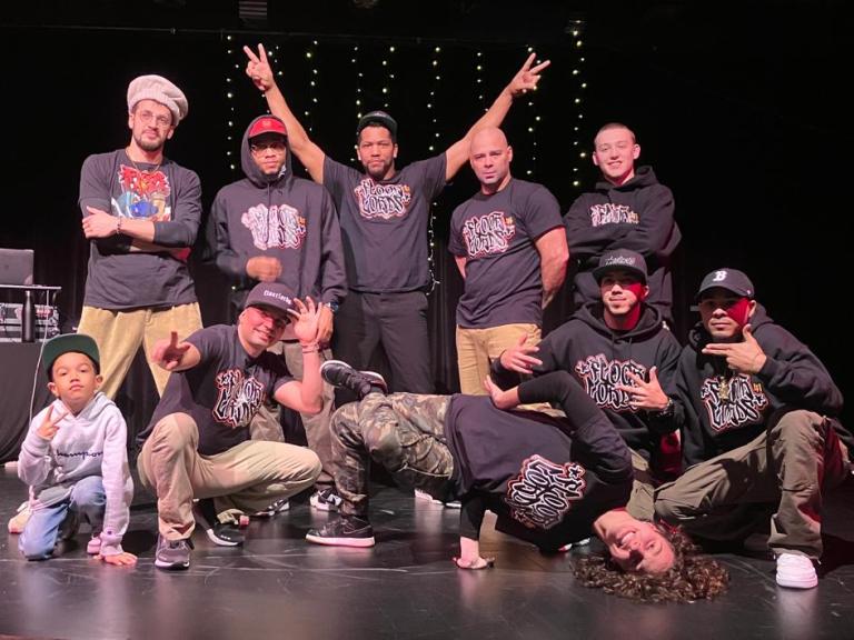 10 people posing for a photo on a stage