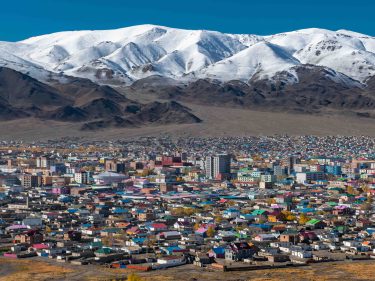 A city in Mongolia with mountains in the background